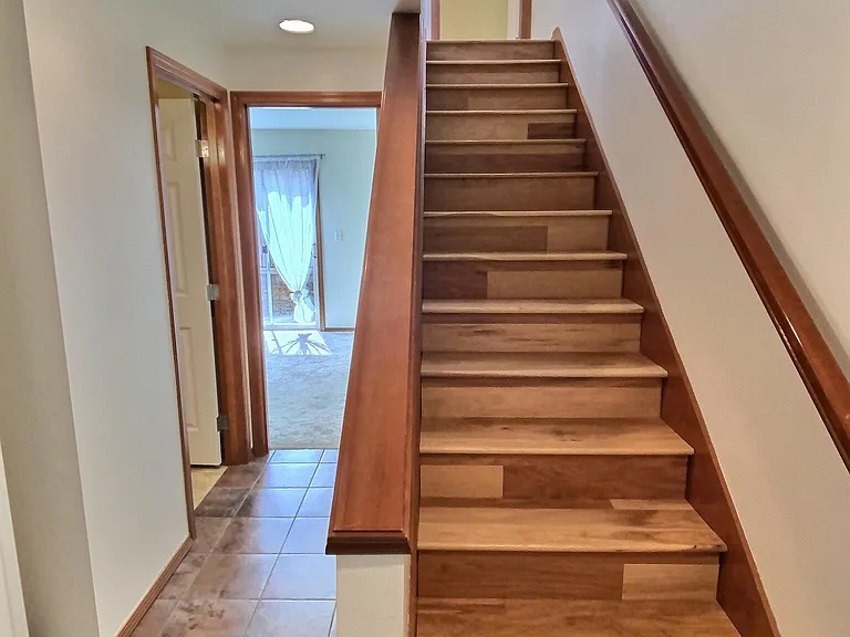 1st Floor _ Private bedroom with direct access to a sunny, private patio, plus a full bathroom, dedicated laundry room with utility sink, and under-stair storage.