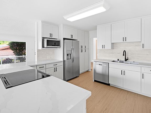Brand new kitchen with stainless steel appliances.