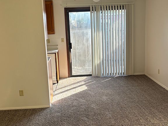 Spacious living and dining area , with patio .