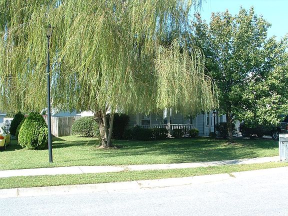 Landscaped yard w/mature trees