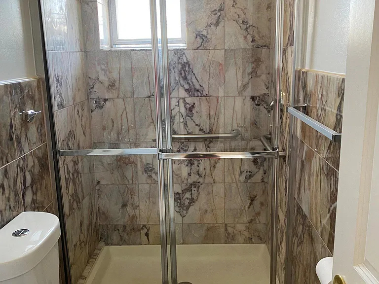 Marble bathroom with new vanity and new shower doors