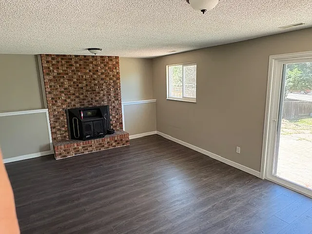 Wood burning fireplace in lower level family room.
