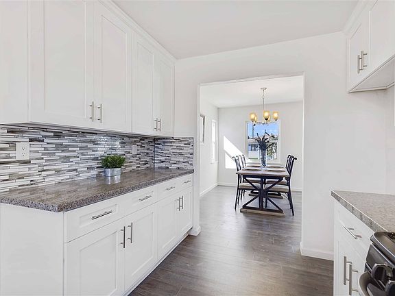New custom kitchen with beautiful quartz counter tops, stainless steel appliances, & new floors.