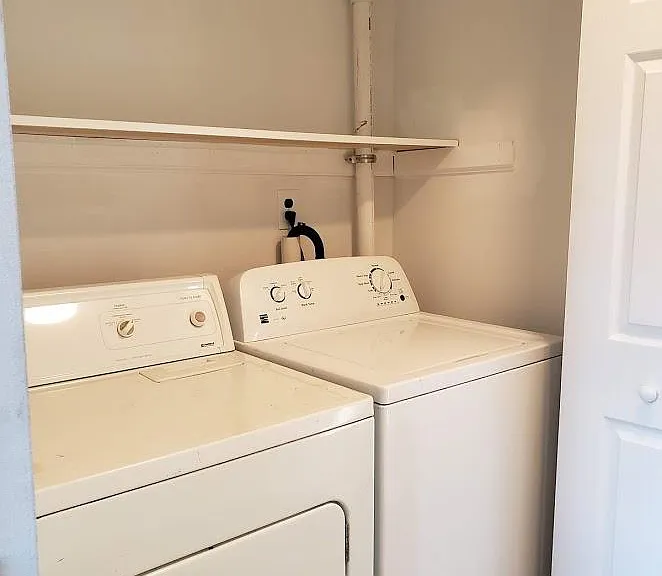 FULL size washer and dryer with plenty of laundry storage.