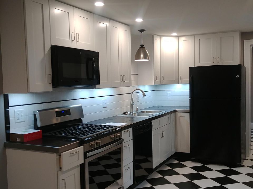 Kitchen with black tile countertops