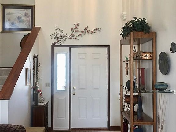 Open entry area with hardwood floors