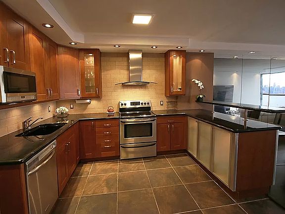 Kitchen with stainless steel appliances: dishwasher, microwave, oven with hood, refrigerator, mini wine fridge