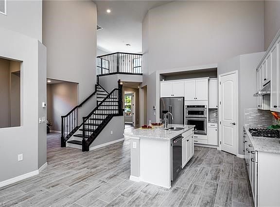 Open concept w/upgraded flooring, cabinets, open stair case and creative layout