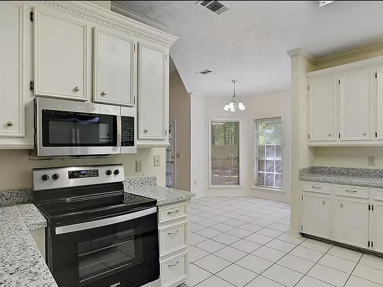 From kitchen can see eat in area. Lots of windows
