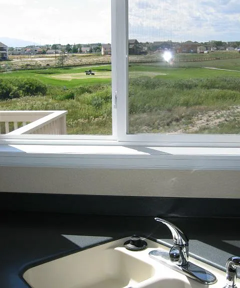 View of the greens as seen from the kitchen sink. The new deck now extends under this window.