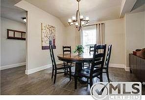 Formal dining area has beautiful iron fixutre and opens to cozy