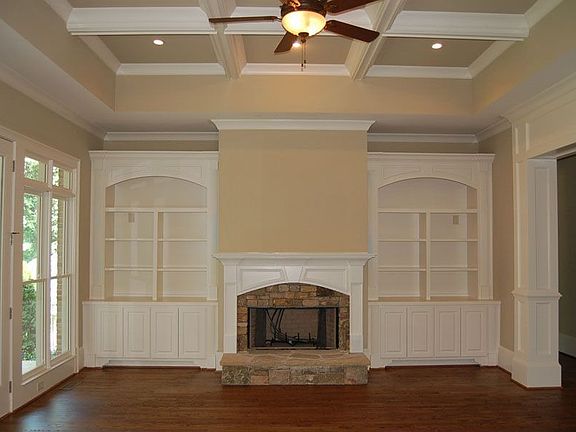 Family Room with coffered ceiling, built-ins, and fp; doors to Covered Porch 