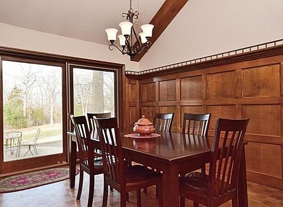 Formal dining room with judge's paneling & new chandelier.