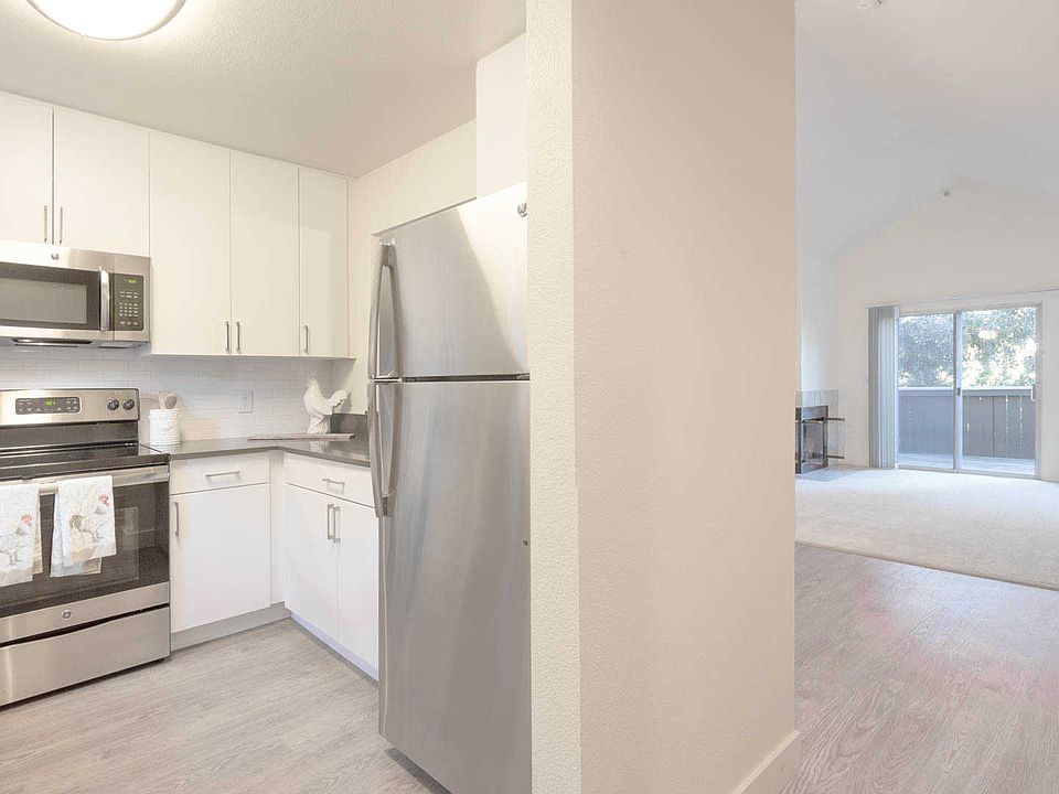 Kitchen with Stainless Steel Appliances and Living Room