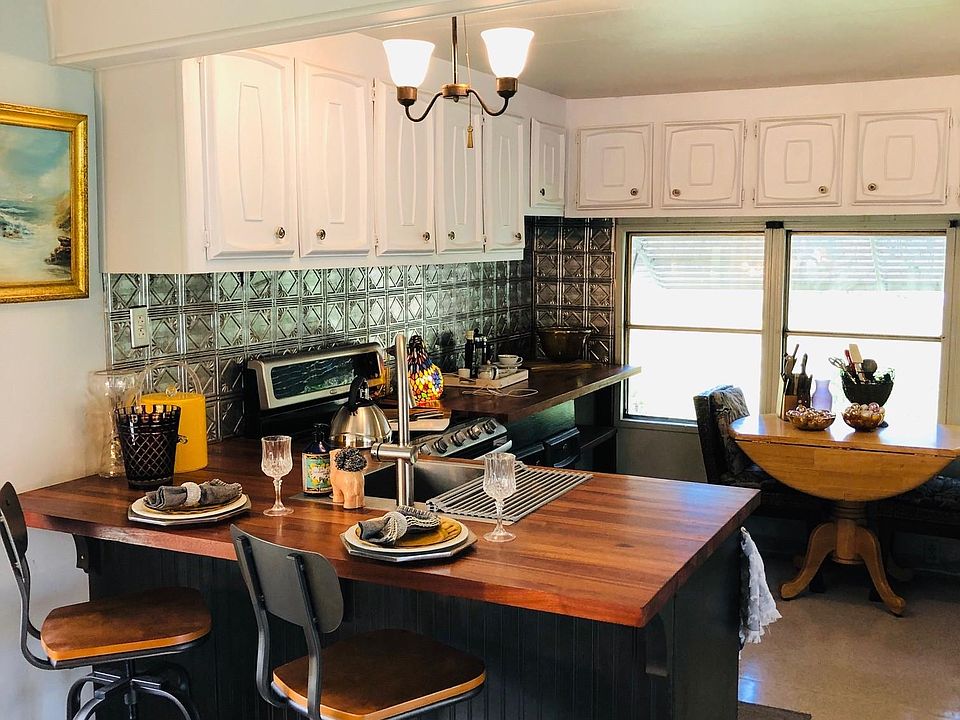 Large Kitchen with new butcher block counter tops & Tin look backdrop. Fully furnished including stove, refrig, microwave and dishes. Newly remodeled. Pic Yr 2020