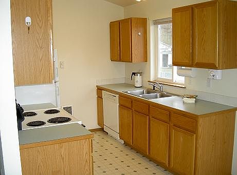 Another photo of the kitchen area. Vinyl planks have replaced this flooring.