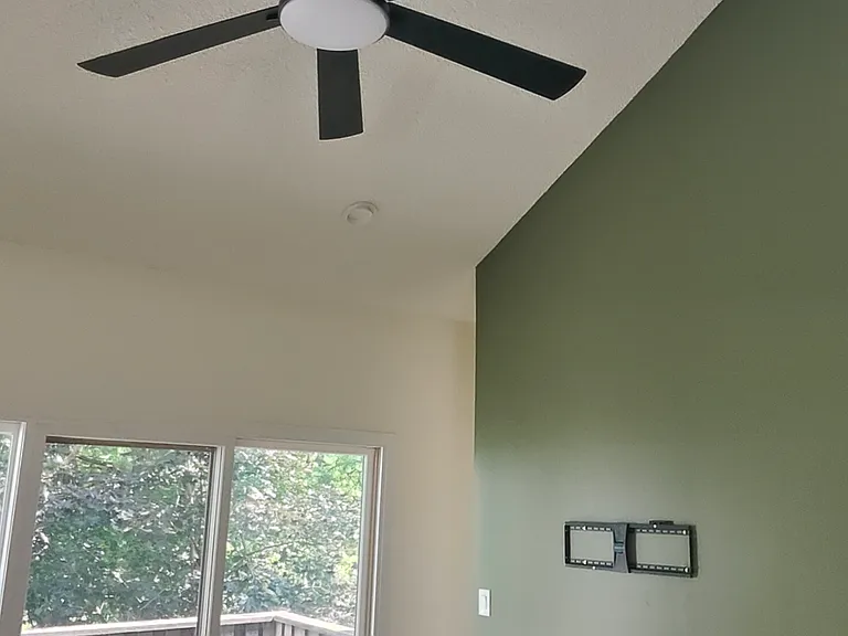 Living room with cathedral ceiling and fire place with tv bracket