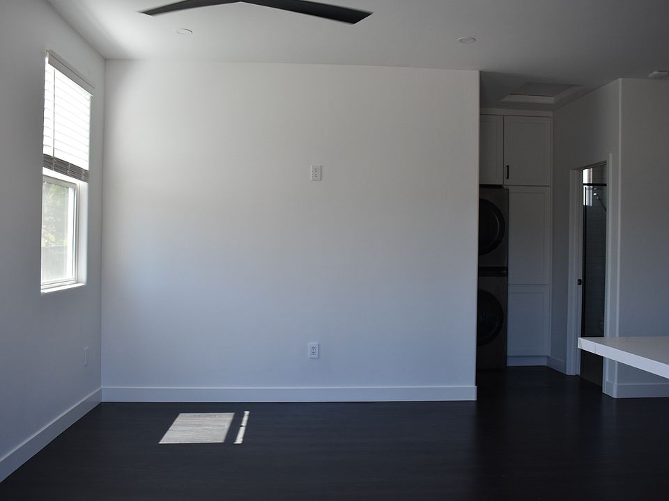 Enter front door to living room area with bright natural light.