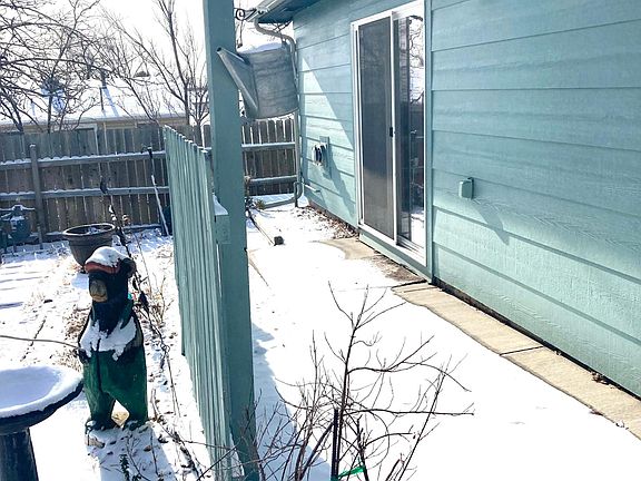 Slider from bedroom out to patio and yard with fruit trees