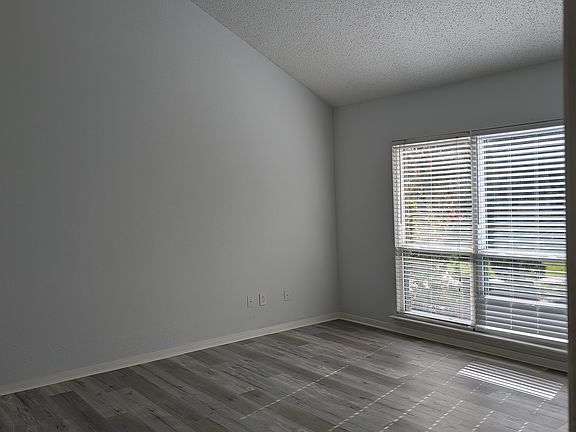 Cathedral ceiling Master bedroom with wall of windows.