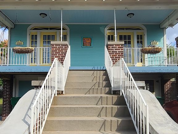 Exterior stairwell entry at front of house. 
1318 is on the right and includes the right side of the front porch area.
1 assigned parking spot is to the right of the stairwell.