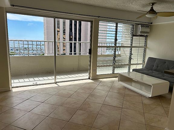 Living Room Oceanview Patio : Ala Moana Beach Park/Magic Island and Ala Moana Boat Harbor. (couch and cocktail table not included if unfurnished).