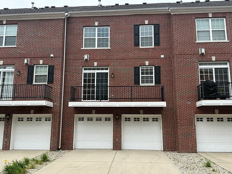 The double garage with the full length balcony off the kitchen / dining area.