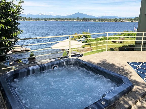 Upper patio with hot tub overlooking the lake