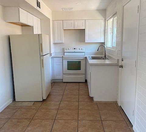 kitchen with new cabinets, countertop, and sink