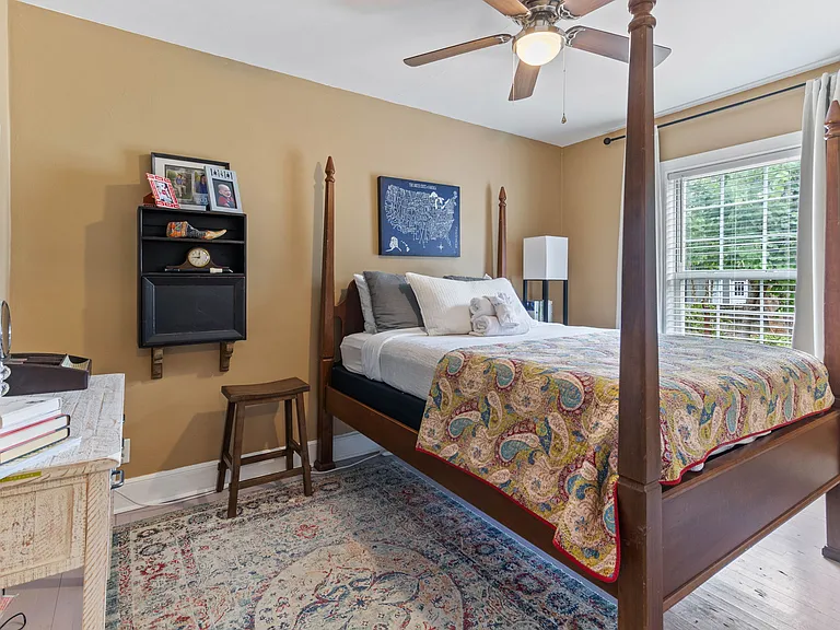 Larson's Room at Hunsucker's Place features a plush memory foam bed, warm decor, and natural light. Conveniently located near Downtown Greensboro and Cone Health Hospital, this cozy space provides comfort and charm in a beautifully central home.