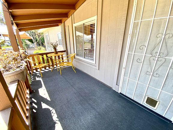 Spacious porch is the perfect spot for coffee or a cocktail!