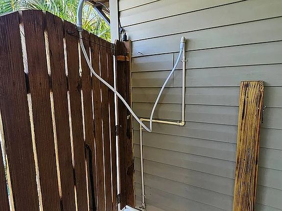 Outside shower for post-beach or boat activities, with wooden door extended as privacy screen