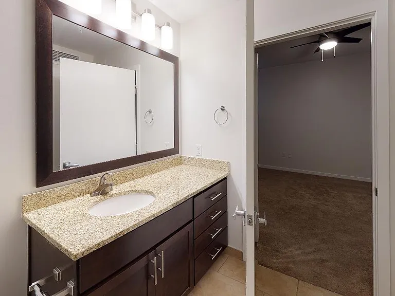 Apartment bathroom with tile flooring.