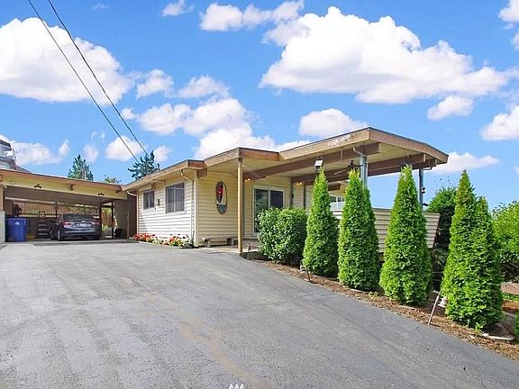 Nice size driveway with carport for two cars. Covered entrance from the carport to the house.