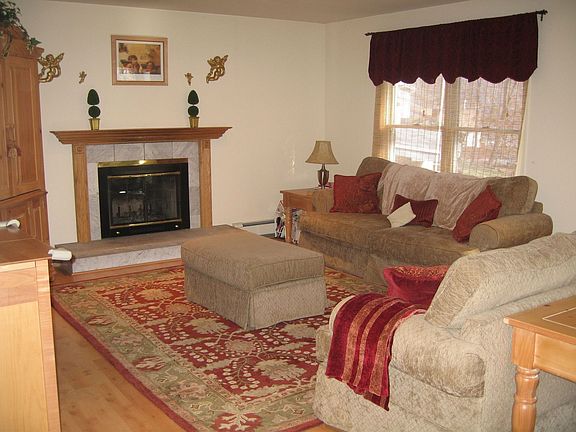 Family Room w/ pergo floors and woodburningmarble  fireplace opens to Kitchen