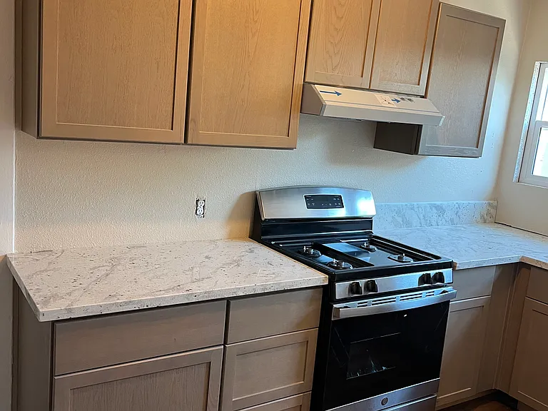 Kitchen with new gas stove, granite and cabinets