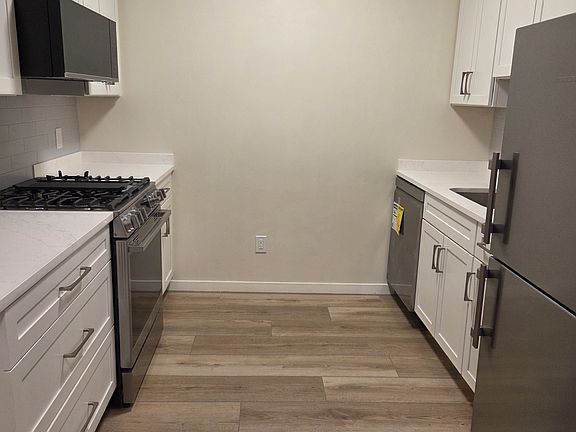 Large galley kitchen with all new stainless steel appliances- Liebherr, LG