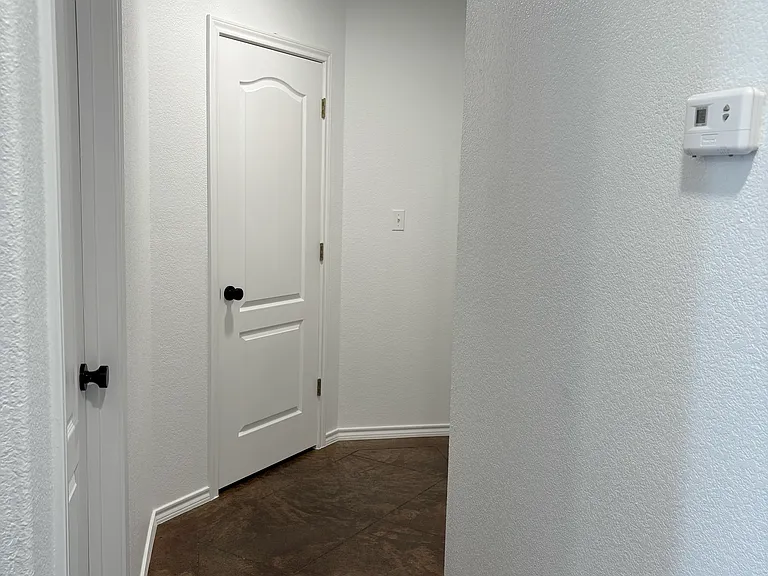 Hallway to the bathroom, linen closet, and two bedrooms.