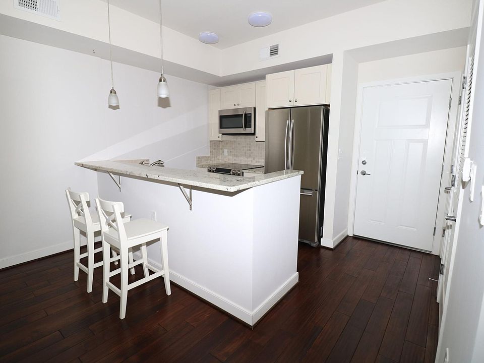 Open kitchen -- stainless steel appliances; breakfast counter