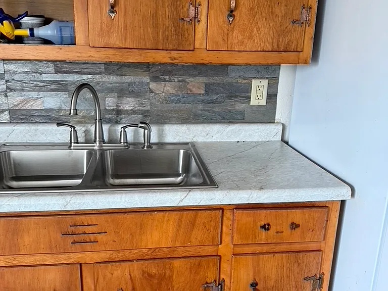 Updated countertop and sink and fucet and backsplash