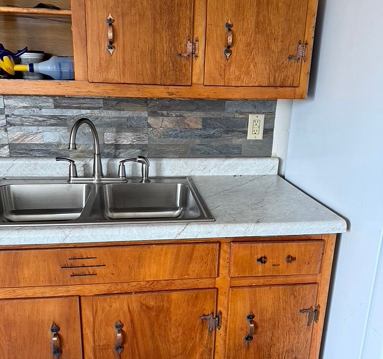Updated countertop and sink and fucet and backsplash