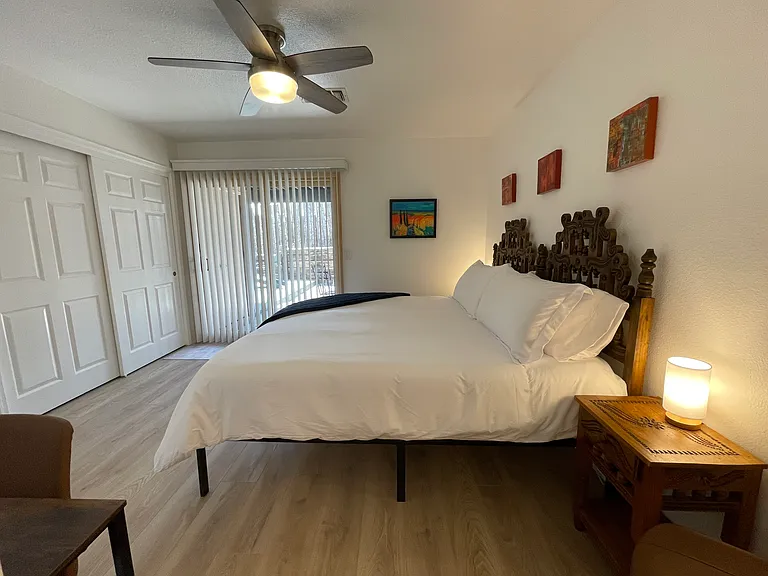 Secondary Bedroom in king bed configuration with access to the downstairs patio