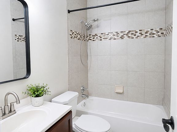 Full bath with shower-tub combo with ceramic tile