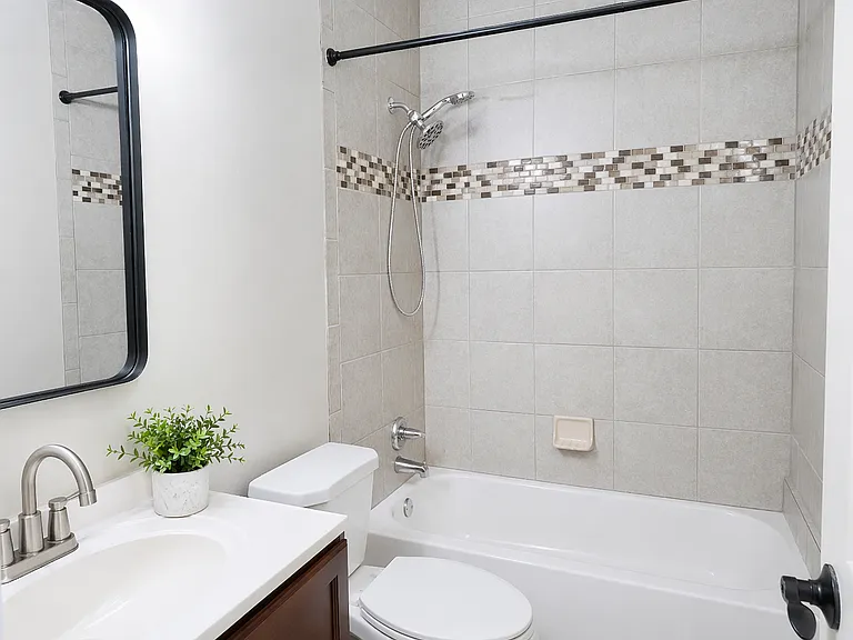 Full bath with shower-tub combo with ceramic tile