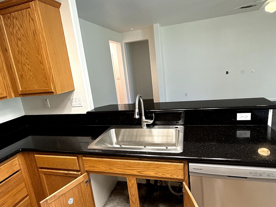 Black granite countertops, new sink, garbage disposal and dishwasher.