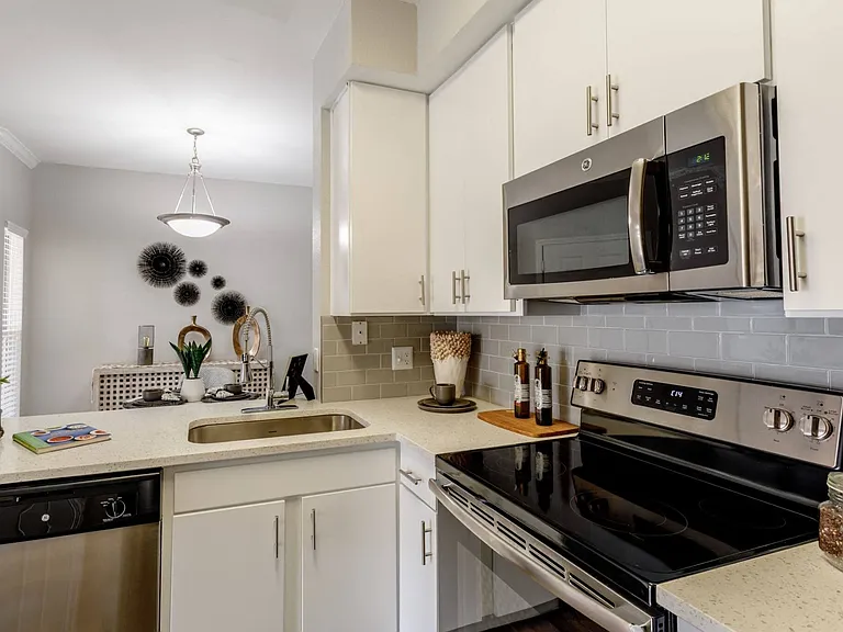 Solid surface countertops and stainless-steel appliances.