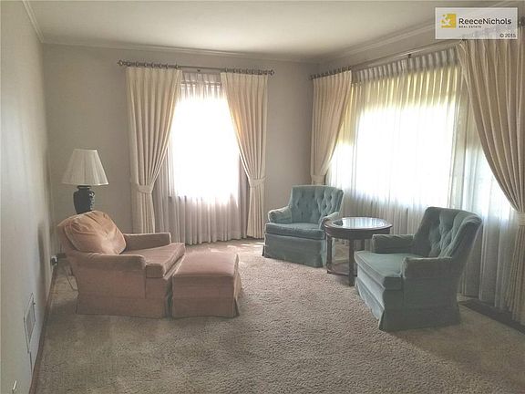 Large living room.  Window coverings and chairs can stay