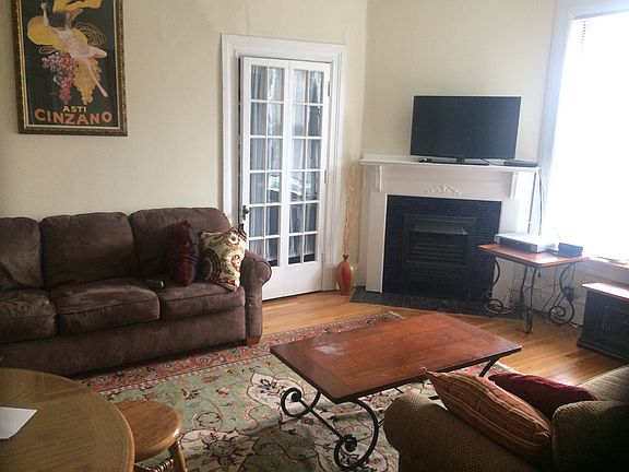 Living room of apartment, looking at fireplace and closet