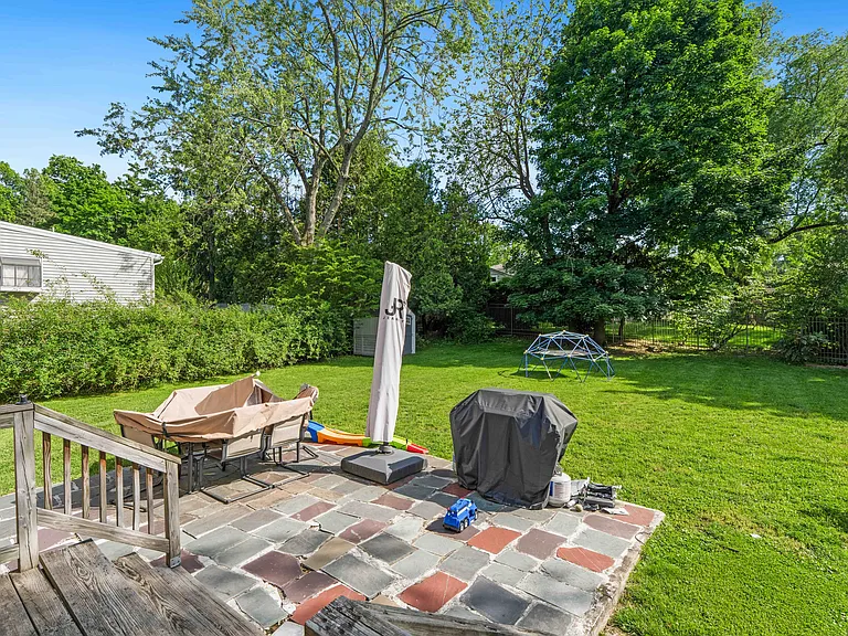 Deck to patio located off kitchen