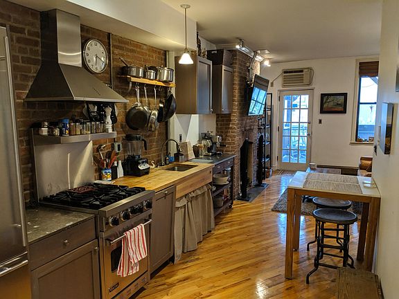 Furnished view of kitchen, facing porch and living room.